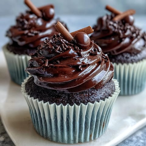 Celebrate graduation with festive cupcakes topped with edible chocolate graduation caps and colorful frosting swirls.  