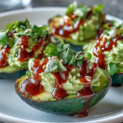 Vibrant deviled eggs filled with avocado and lime, finished with a bold Sriracha kick.  