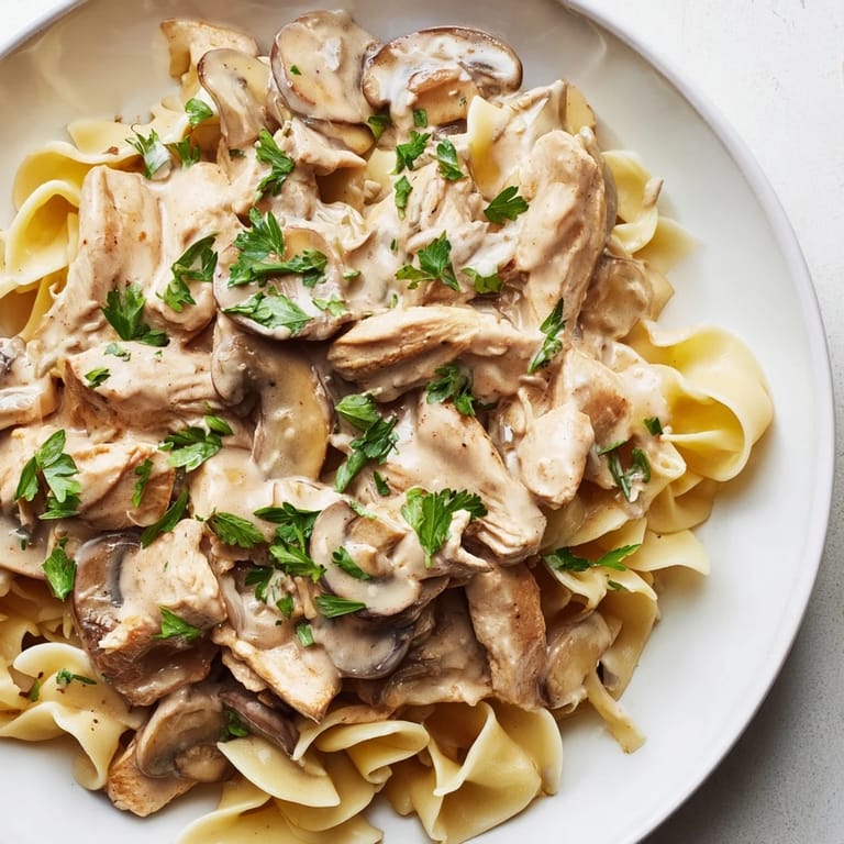 Golden chicken strips and sautéed mushrooms in a rich, paprika-spiced sauce topped with fresh parsley.