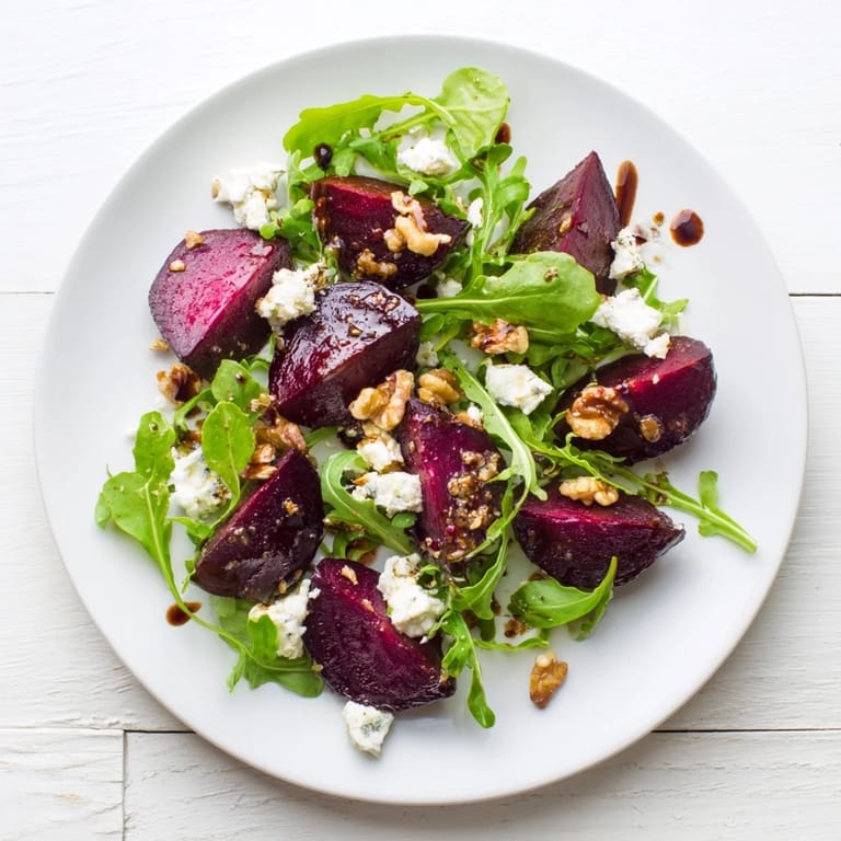 A beautifully plated Roasted Beet Goat Cheese Salad showcases tender beet cubes, sharp goat cheese, and crunchy walnuts over fresh arugula leaves, ready for a nutritious American lunch.