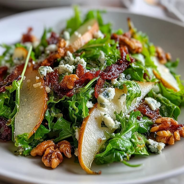 Close-up of a vibrant Frisée Pear Blue Cheese Bowl showcasing frisée greens, walnuts, and zesty vinaigrette drizzle.