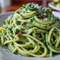 Vibrant Creamy Avocado Pesto Pasta, a quick no-cook sauce over al dente spaghetti.